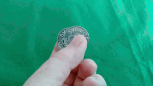 Illustration of illusion of third coin when two coins are moved quickly in fingertips.